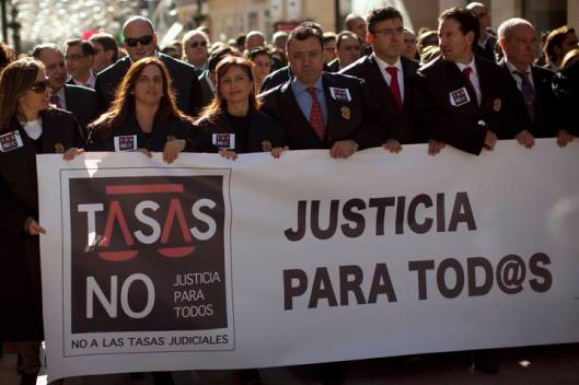Lawyers take part in a demonstration against the new law of the court fees imposed by Spain's Justice Minister Gallardon, in Malaga